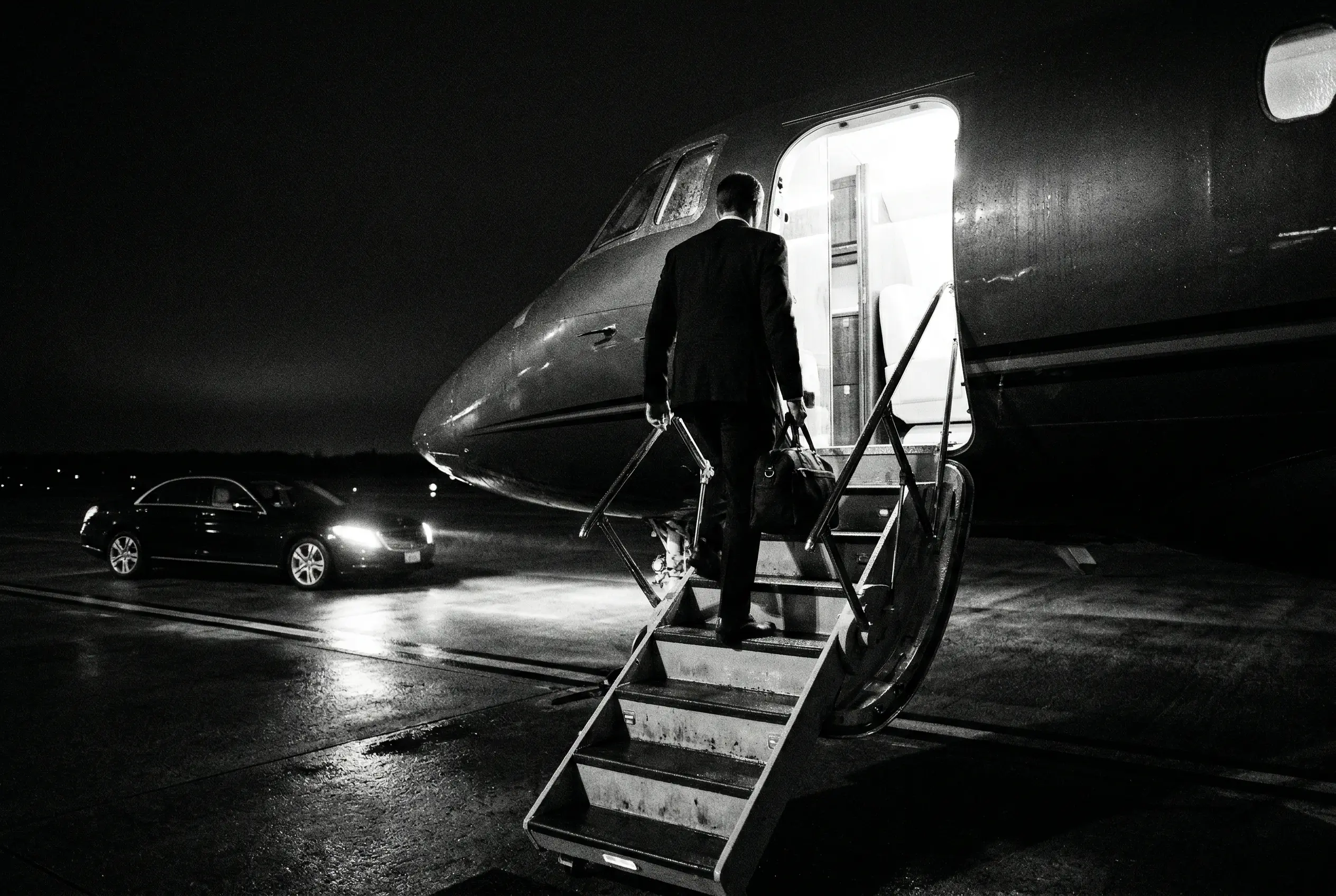 Passengers boarding a Hawker 800XP on the tarmac at a private terminal